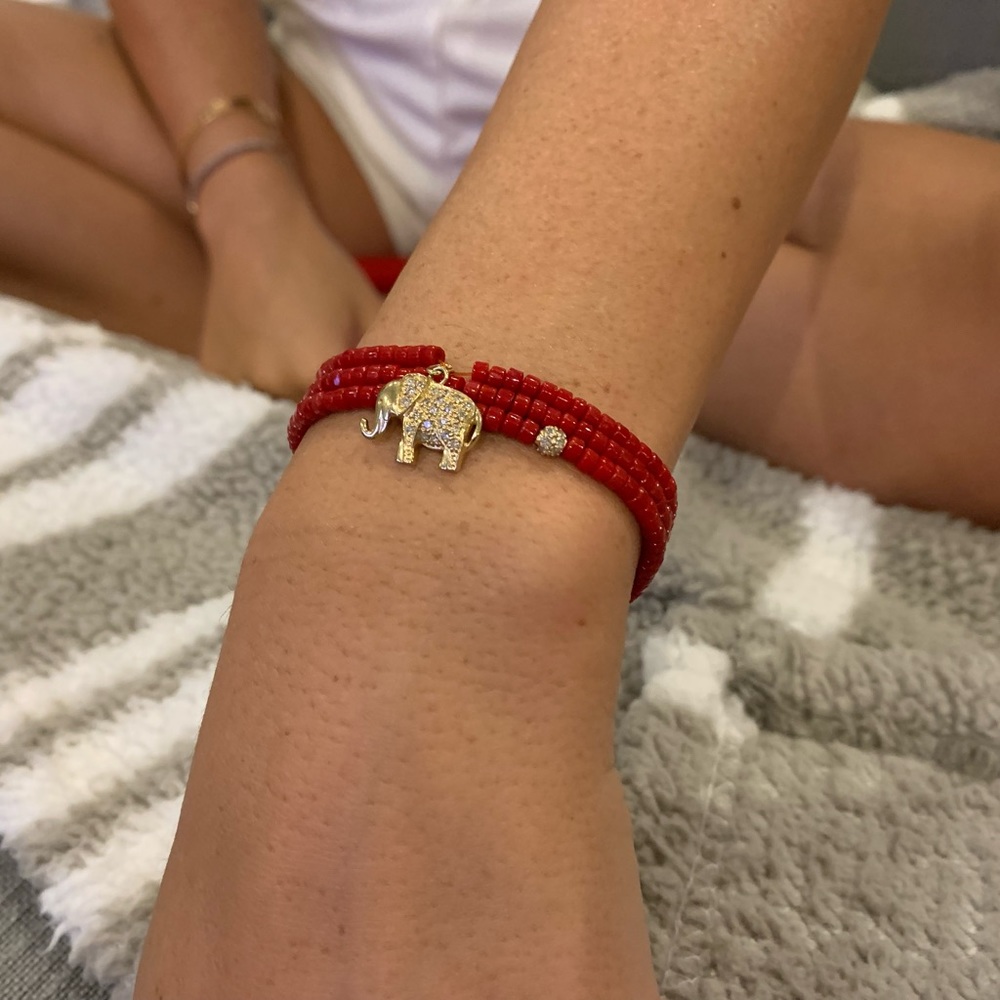 Red beaded wrap bracelet with diamond pave ball and elephant charm